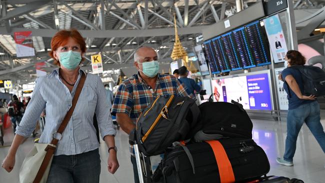 The threat of coronavirus is still very real for people using and working at airports. Picture: AFP