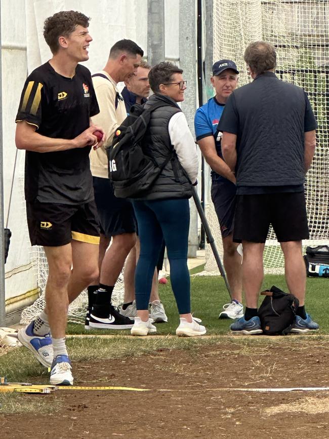 AFLW premiership coach Bec Goddard (c) with New Zealand coach Gary Stead (facing, back).