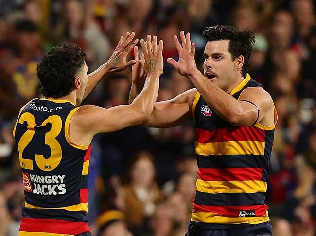 ADELAIDE, AUSTRALIA - MARCH 22: Darcy Fogarty of the Crows celebrates a goal with Izak Rankine of the Crows during the 2024 AFL Round 2 match between the Adelaide Crows and the Geelong Cats at Adelaide Oval on March 22, 2024 in Adelaide, Australia. (Photo by Sarah Reed/AFL Photos via Getty Images)