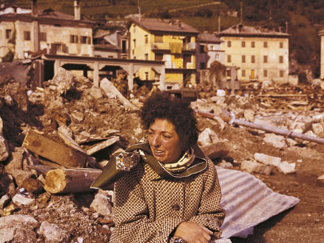 A woman sits crying amid the debris. She survived to the disastrous giant wave, caused by a slope of Mount Toc into the Vajont dam, destroying the village of Longarone and killing more than 2,000 people.