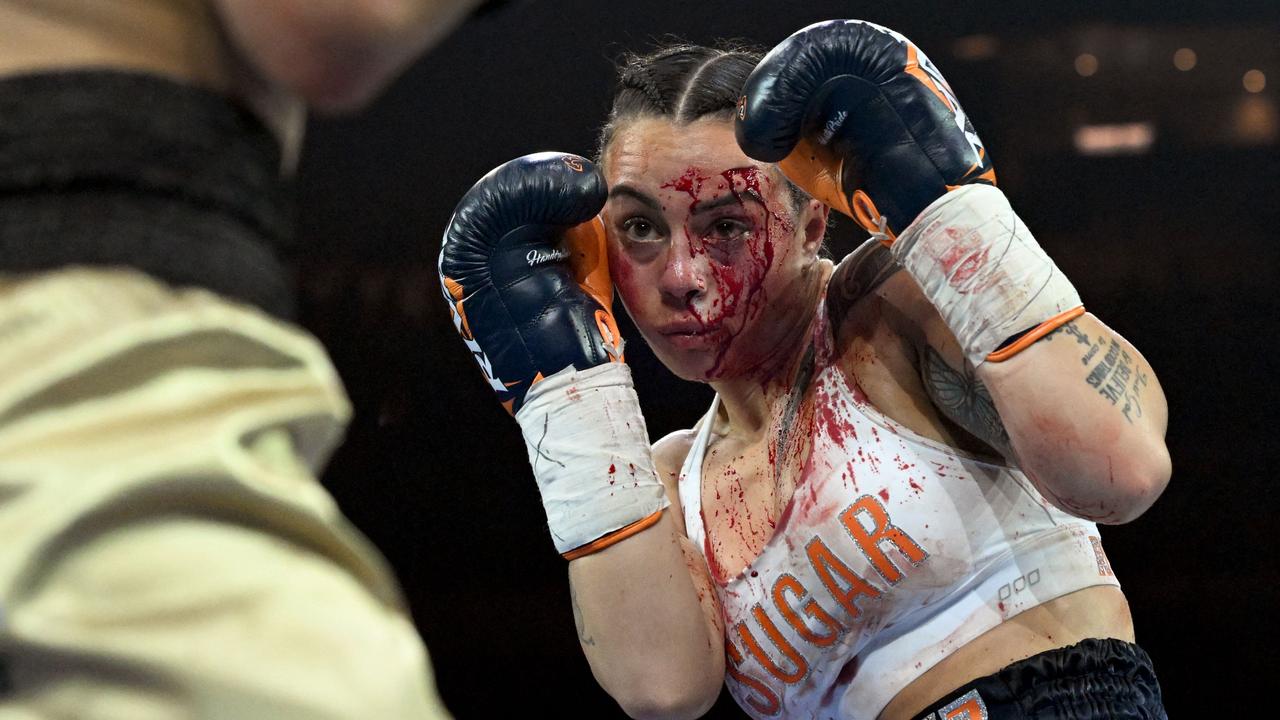 TOPSHOT - Cherneka Johnson of New Zealand fights Susie Ramadan of Australia during their IBF super-bantamweight boxing world title bout in Melbourne on October 16, 2022. (Photo by William WEST / AFP) / -- IMAGE RESTRICTED TO EDITORIAL USE - STRICTLY NO COMMERCIAL USE --