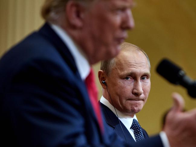 Russia's President Vladimir Putin listens while US President Donald Trump speaks during a press conference at Finland's Presidential Palace July 16, 2018 in Helsinki, Finland. The US and Russian leaders opened an historic summit in Helsinki, with Donald Trump promising an "extraordinary relationship" and Vladimir Putin saying it was high time to thrash out disputes around the world.  / AFP PHOTO / Brendan Smialowski