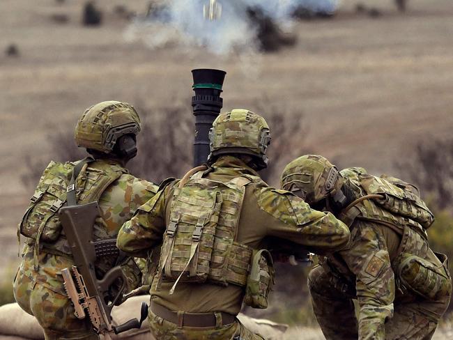 (FILES) A file photo taken on May 9, 2019 shows Australian Army soldiers firing an 81mm mortar round during Excercise Chong Ju, a live fire demonstration showcasing the army's joint combined arms capabilities, at the Puckapunyal Military Base some 100 kilometres north of Melbourne. - Australia launched its biggest defence shakeup in decades on April 24, 2023, vowing to turn a military that is "no longer fit for purpose" into a fighting force that could deter China or any would-be foe. (Photo by William WEST / AFP)