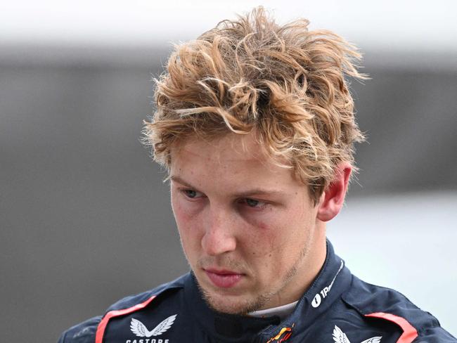 Red Bull Racing's New Zealand driver Liam Lawson walks back to his team garage after getting out of his car at the end of the Formula One Chinese Grand Prix in Shanghai on March 23, 2025. (Photo by GREG BAKER / AFP)