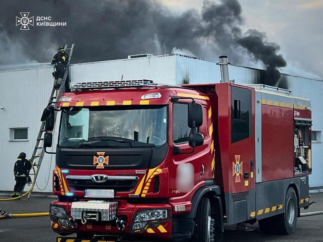 Rescuers put out a fire in a building following drone attacks on the Kyiv region. Picture: Handout/Ukrainian State Emergency Service/AFP