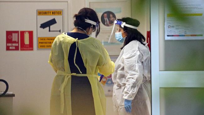 Staff wearing PPE inside an aged care facility. Picture: Nicholas Eagar