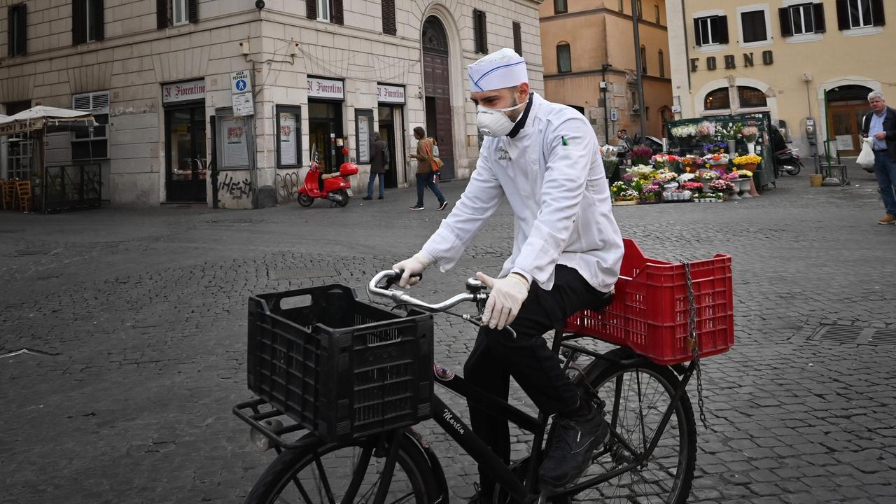 A cook wearing a respiratory mask in Rome. Italy’s coronavirus cases have now exceeded mainland China. Picture: Alberto Pizzoli/AFP