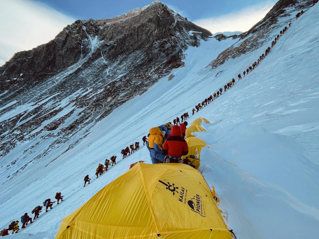 Mountaineers lined up as they climb a slope during their ascend to summit Mount Everest in Nepal in 2021. Picture: Lakpa Sherpa / AFP