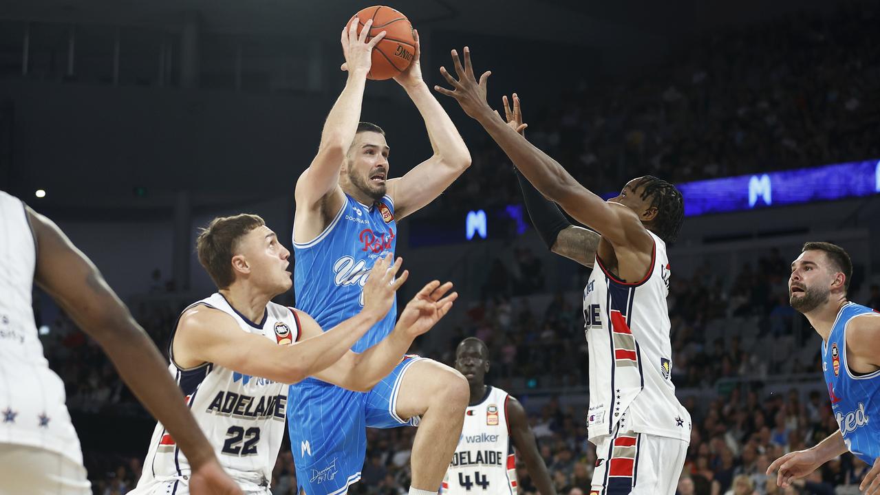 Chris Goulding of United drives to the basket under pressure from Antonius Cleveland of the 36ers and Hyrum Harris of the 36ers. (Photo by Daniel Pockett/Getty Images)