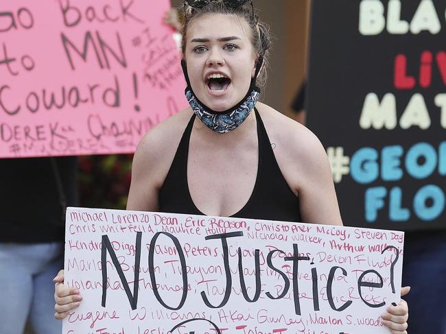 Protesters yell outside a home in Florida. Picture: AP