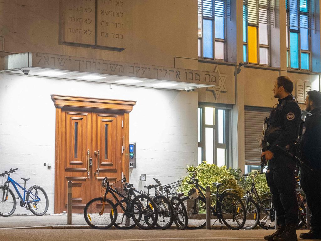 Police officers stand guard at the Synagogue Agudas Achim in Zurich after an Orthodox Jewish man was stabbed. Picture: AFP