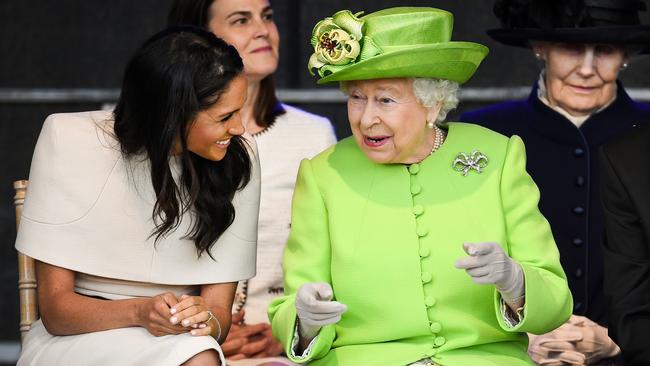 Queen Elizabeth II (right) speaks with Meghan, Duchess of Sussex, during a ceremony to open the new Mersey Gateway Bridge on June 14, 2018. Picture: Getty Images