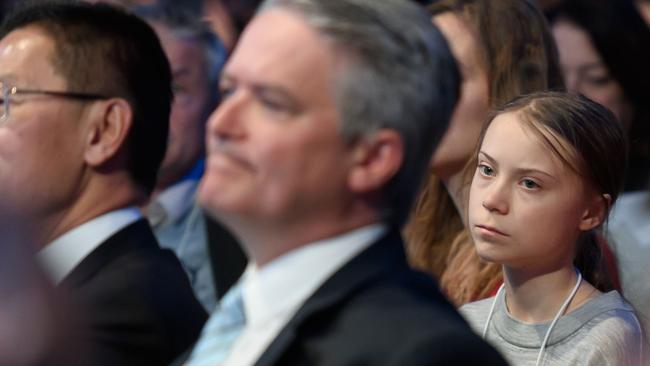 Greta Thunberg sits behind Mathias Cormann as they listen to Donald Trump’s speech. Picture: AFP