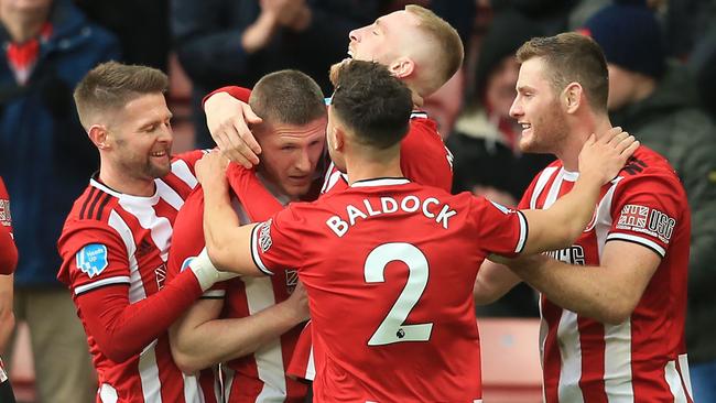 Sheffield United's English midfielder John Lundstram (2nd L) celebrates with teammates after scoring their second goal during the English Premier League football match between Sheffield United and Bournemouth at Bramall Lane in Sheffield, northern England on February 9, 2020. (Photo by Lindsey Parnaby / AFP)