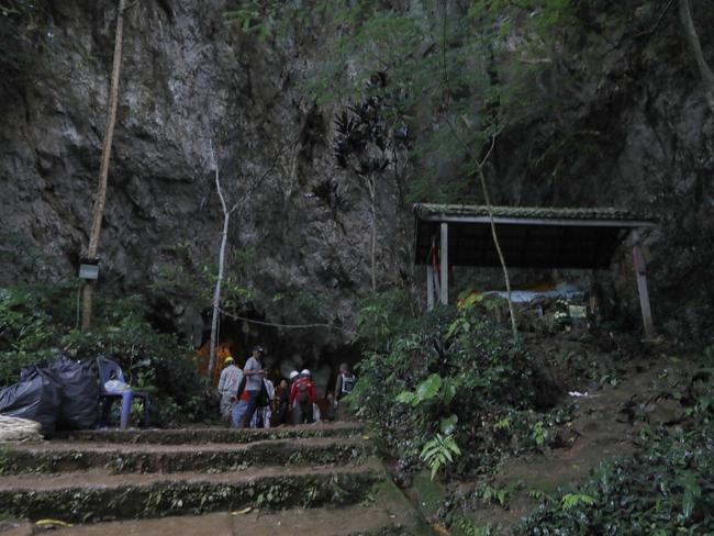 Rescue teams gather at the cave’s entrance. Picture: AP
