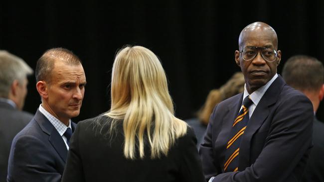 U.S. Olympic track champion Edwin Moses (right) talks with US anti-doping agency CEO Travis Tygar and Zimbabwean swimmer Kirsty Coventry.