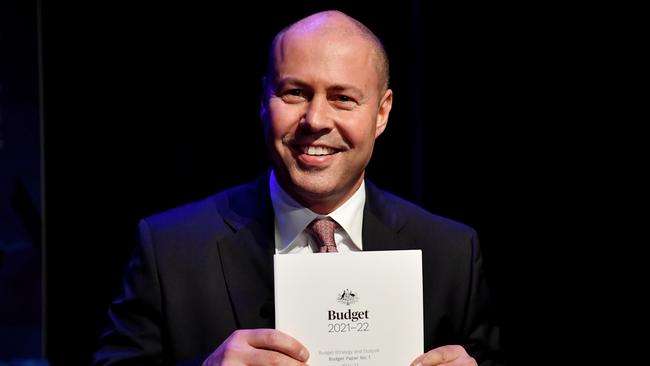 Now for the hard part .... Josh Frydenberg holds a copy of his third budget. Picture: Getty Images