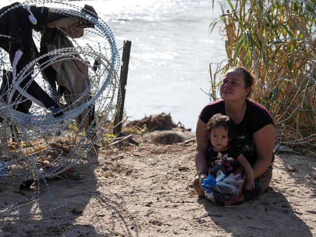 Maria Argentina, 32, from Honduras, cries after being reunited with her daughter after crossing the Rio Grande river without her wheelchair. Dozens of migrants arrived at the US-Mexico border this week, as US border forces report 1.8 million encounters with migrants in the last 12 months. Picture: Andrew Caballero-Reynolds/AFP