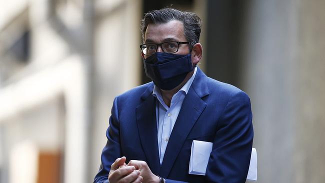 Daniel Andrews dons his mask after speaking at Monday’s press conference. Picture: Daniel Pockett/Getty Images