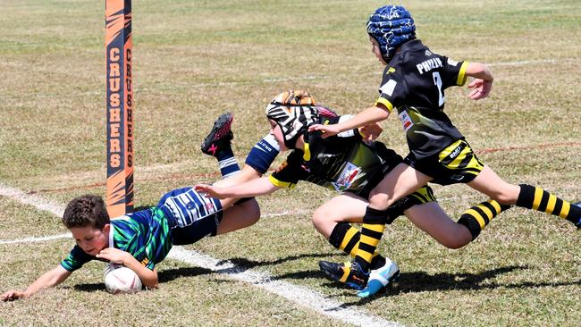 Townsville Brothers Blue star Jason Ward scores a cracker of a try in the corner at the sixth annual Dean Schifilliti Shield for U8 rugby league players from throughout North Queensland at Artie Gofton Oval in Ingham on Saturday. Picture: Cameron Bates