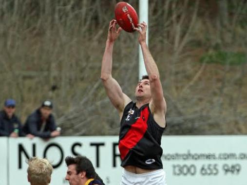 Former AFL St Kilda listed player Jarryd Allen takes a towering mark over two Rupertswood opponents. Photo: Aaron Cook.