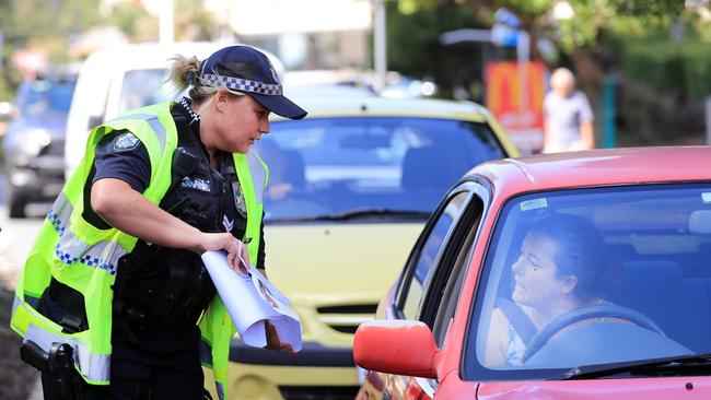 A police officer speaks to a driver at the border crossing between Queensland and New South Wales. Picture: Scott Powick