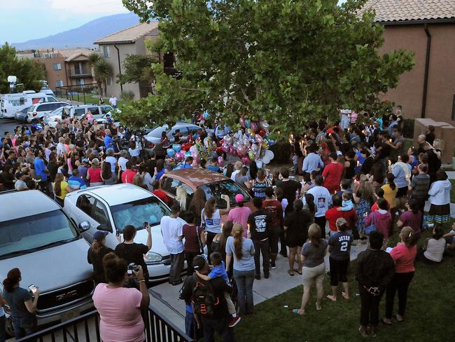 A few hundred people attend a candlelight vigil for 10-year-old Victoria Martens at the apartment complex in Albuquerque where she died. Picture: AP