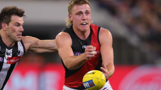 Josh Begley gets away a handball for the Bombers against Collingwood in 2019.