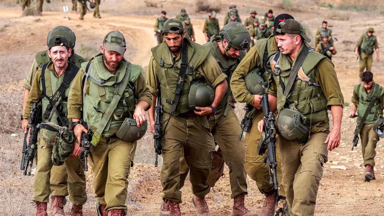 Israeli army soldiers return after searching for human remains following the October 7 attacks carried out by Palestinian militants. Picture: AFP