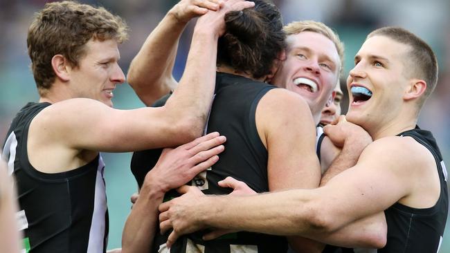 Collingwood's Brodie Grundy is mobbed by teammates after a final-term goal. Pic: Michael Klein