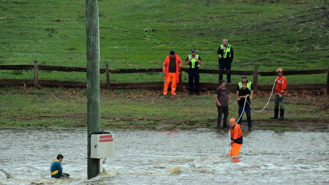 Rescuers send a line out to the boy who had become stranded at Tynwald Park. Picture: DAMIAN BESTER