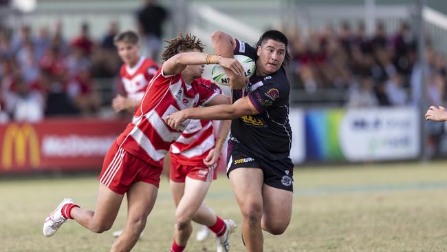 Marsden SHSÃ¢â¬â¢s Jury Taewa (18) breaks a tackle from Palm Beach Currumbin State HighÃ¢â¬â¢s Jac Finigan (12)