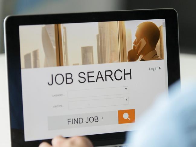 Monitor view over a male shoulder, job search title on the screen, close up. Education, business concept photo