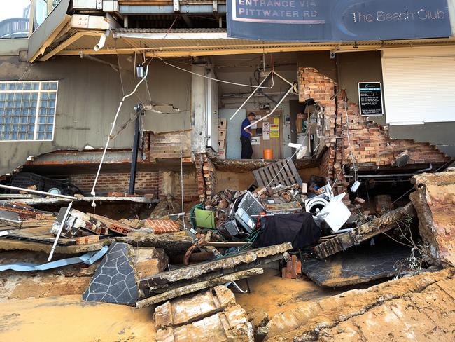 A man stands inside the destroyed Beach Club at Collaroy. Picture: AAP