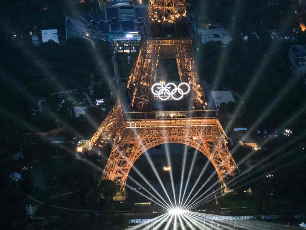 This photograph taken from an helicopter on July 26, 2024 in Paris shows an aerial view of the Eiffel Tower and the Olympics Rings illuminated during the opening ceremony of the Paris 2024 Olympic Games. Picture: AFP