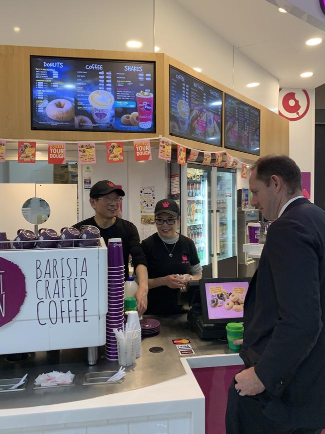 Donut King owners Patrick and Alice Wu serving Inner West Mayor Darcy Byrne on the Green Caffeen launch day.