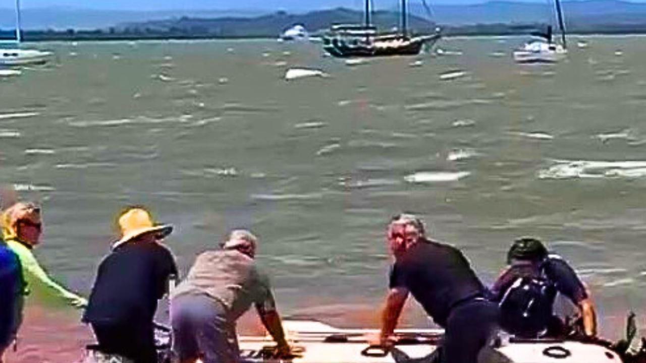 Boat owners T Redland Bay ready to get into a tender to go to their boats which are on moorings in the bay, where winds gusts have been clocked at more than 60km/h over night. Picture: Contributed