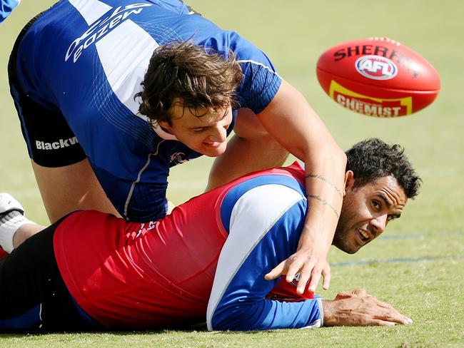 Daniel Wells is tackled by Braydon Preuss at North Melbourne training. Picture: Colleen Petch.