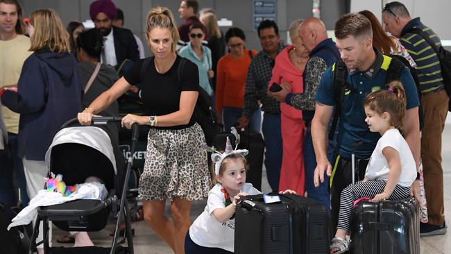 David and Candice Warner arrive at Melbourne airport with their family