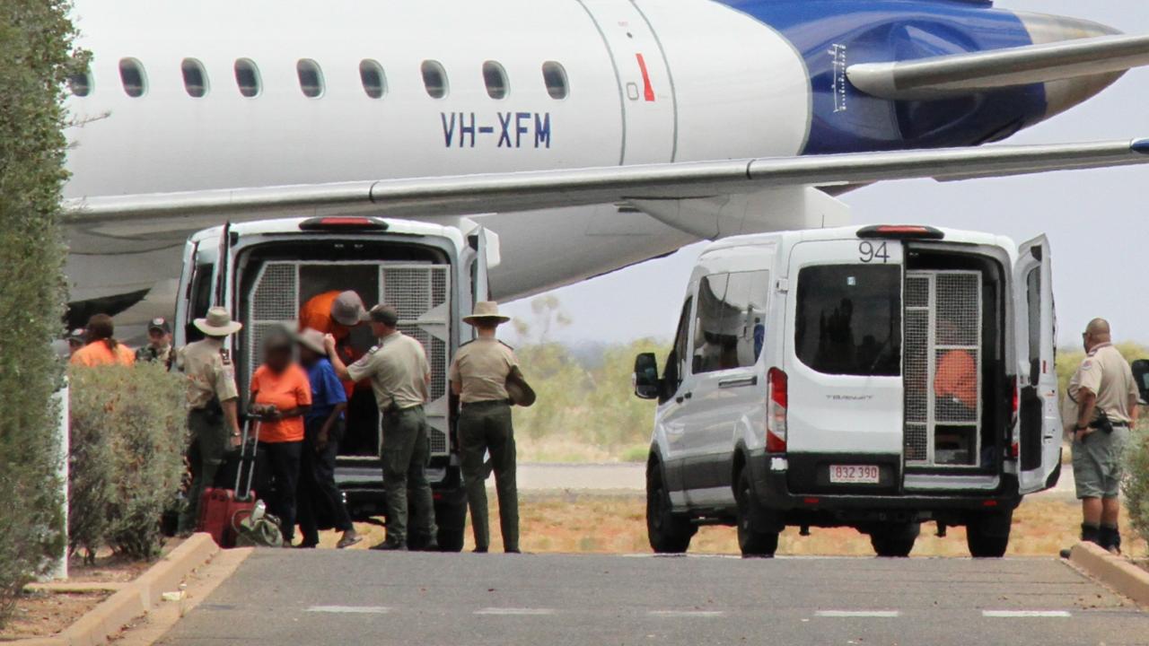 Prisoners prepare to board a chartered flight to Darwin at Alice Springs Airport. Picture: Gera Kazakov