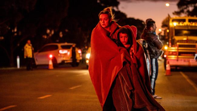 Children are helped to safety after the crash. Picture: Jake Nowakowski