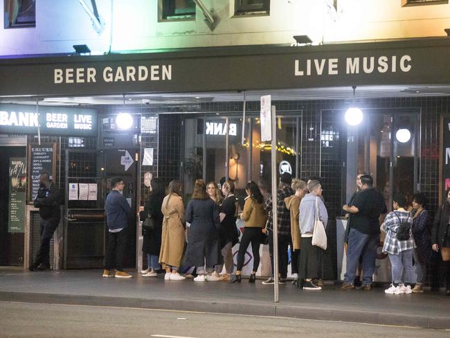 People queue up outside the Bank Hotel in Newtown. Sydney on Saturday night. Picture: Damian Shaw