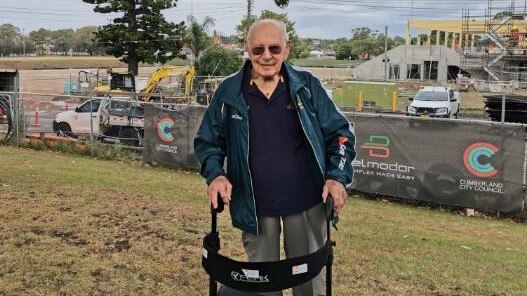 Eric Tweedale at Granville Park with the stadium to be named in his honour under construction in the background.