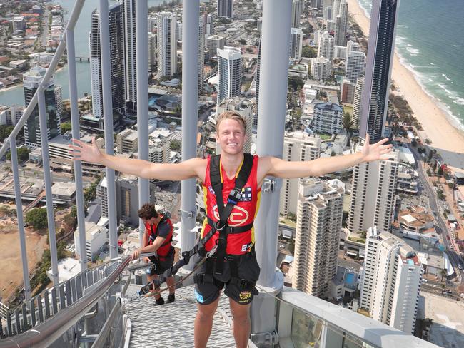 Gold coast Suns player Jack Lukosius on top of the Gold Coast doing the Skypoint climb on Q1. Picture Glenn Hampson