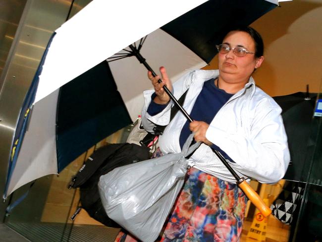 Elena Bobolas leads her mother Mary and sister Liana from court after turning up with $180,00 cash after a magistrate ordered the sale of their hoarders’ house. Picture: Stephen Cooper