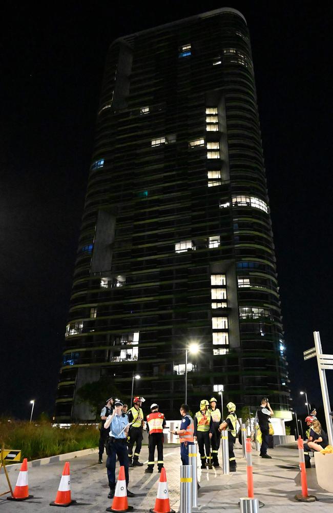 Police and firefighters n front of the Opal Tower last night. Picture: AFP