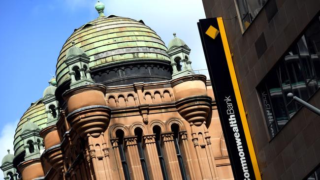 A Commonwealth Bank of Australia (CBA) sign adorns the side of a building in Sydney on August 28, 2017. The woes mounted for Australia's biggest bank on August 28 with an independent inquiry to be launched into its governance, culture and accountability after it was accused of breaching anti-money laundering legislation. / AFP PHOTO / William WEST