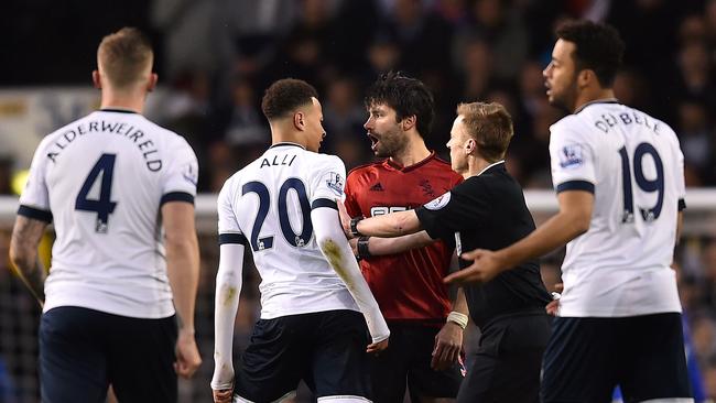 Tottenham Hotspur midfielder Dele Alli speaks with West Bromwich Albion midfielder Claudio Yacob.