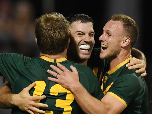 James Tedesco of the Kangaroos celebrates his try with team mates Jake Trbojevic and Daly Cherry-Evans after scoring a try during the Oceania Cup Test Match between Australia and New Zealand at WIN Stadium in Wollongong, Friday, October 25, 2019. (AAP Image/Dean Lewins) NO ARCHIVING, EDITORIAL USE ONLY