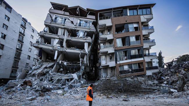 A rescue worker walks past partially collapsed buildings in the city of Antakya. Picture: AFP